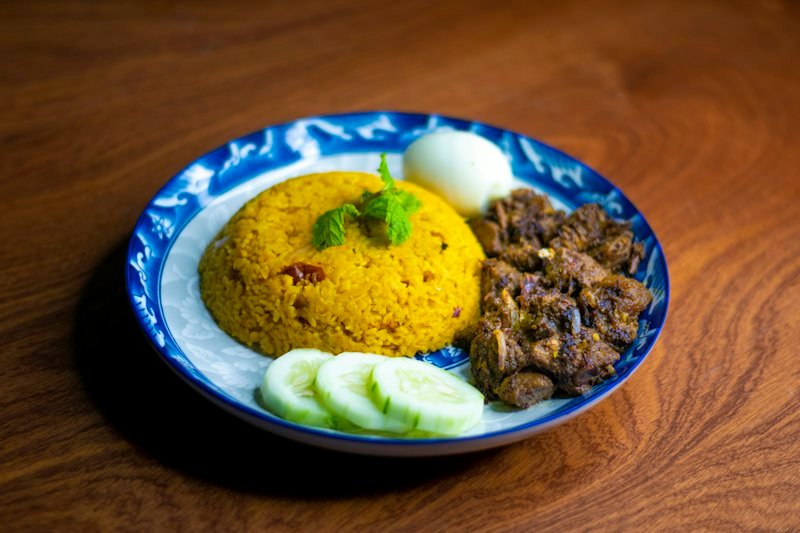 Chicken biryani served with rice and accompaniments