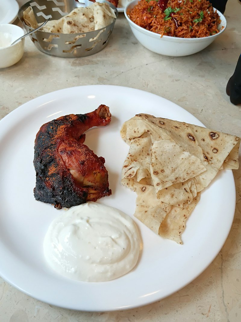 Tandoori chicken served with flatbread and yoghurt dip